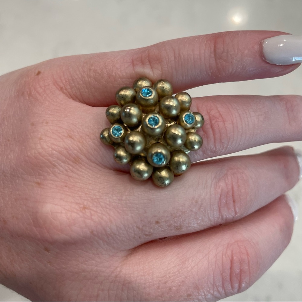 Gold ring with light blue stones on a stretchy band